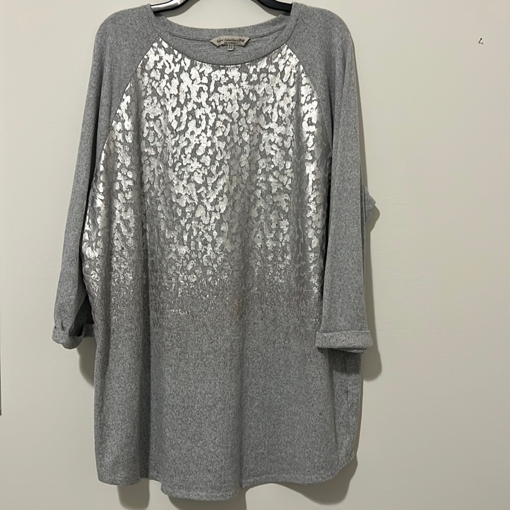 Tunic jersey knit top with shimmery metallic pattern.